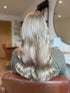 ashy blonde hair with a wave style representing the results of a full head of foils