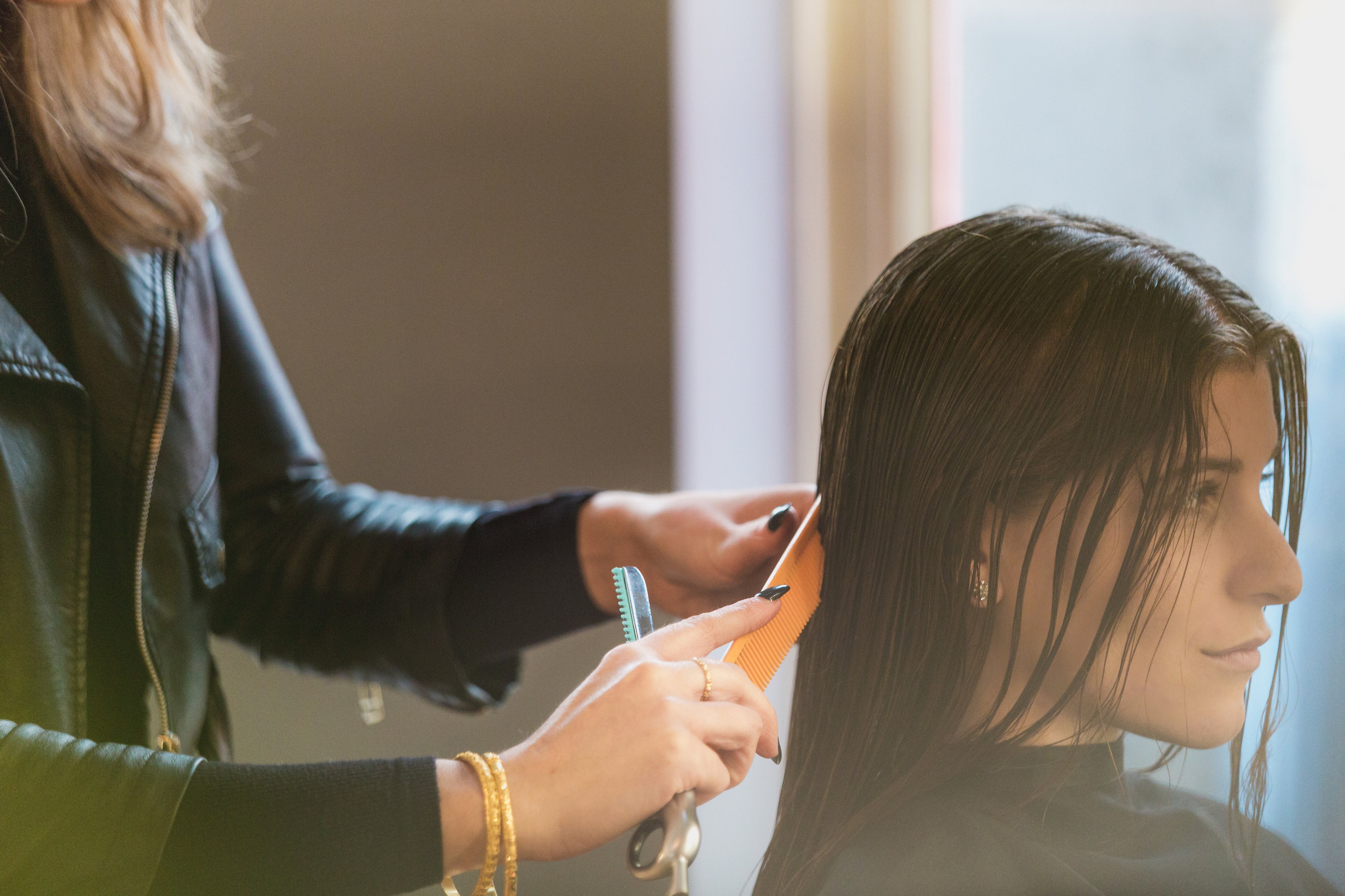 hairdressing combing woman's hair